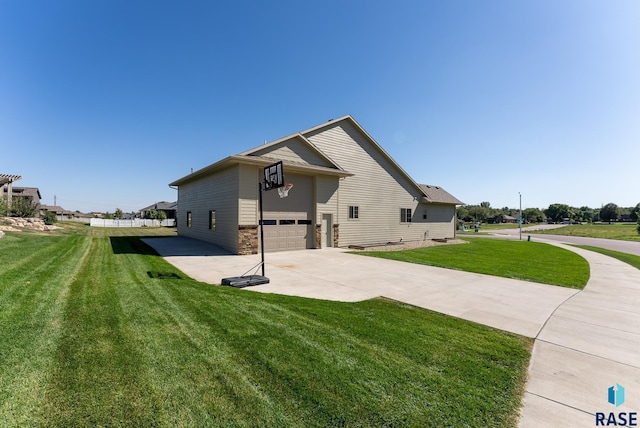 exterior space with a garage and a yard