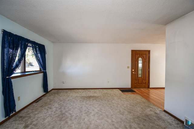 foyer featuring hardwood / wood-style flooring and a textured ceiling