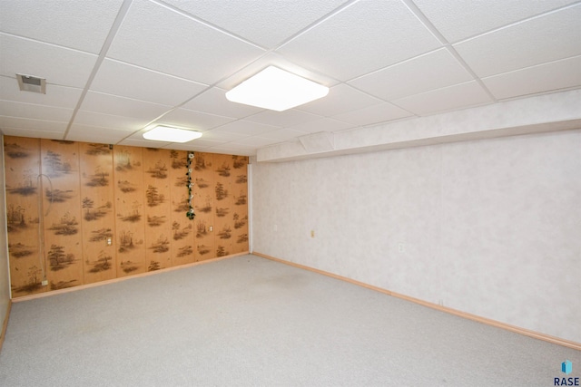 basement featuring a drop ceiling and carpet flooring