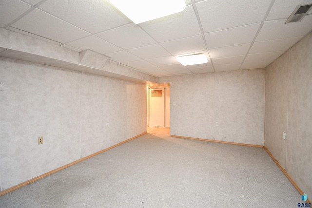 spare room with a drop ceiling and carpet floors