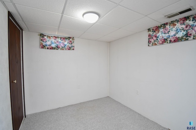 basement featuring carpet flooring and a drop ceiling