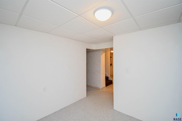 spare room with carpet flooring and a drop ceiling