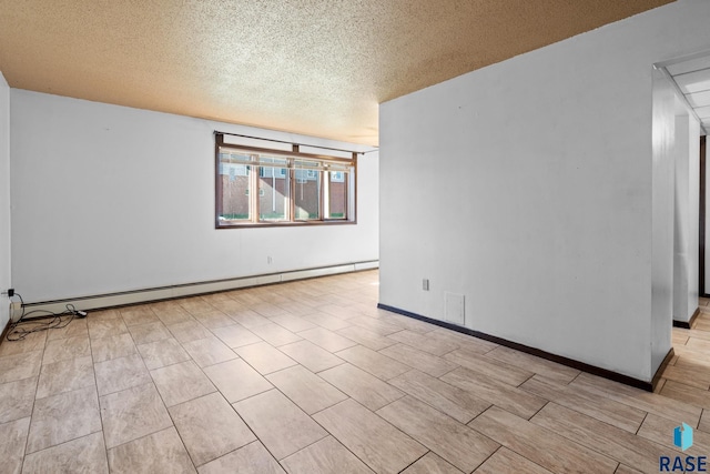 empty room featuring a textured ceiling and baseboard heating