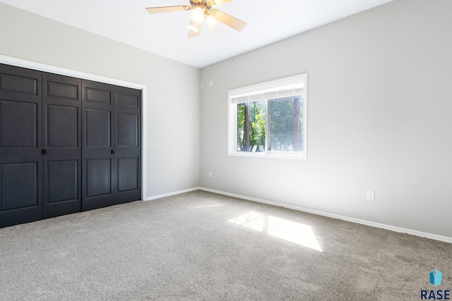 unfurnished bedroom with ceiling fan, carpet floors, and a closet