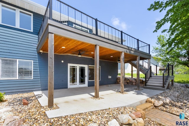 back of property featuring ceiling fan, a deck, and a patio