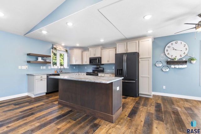 kitchen with stainless steel appliances, ceiling fan, a center island, and dark hardwood / wood-style flooring