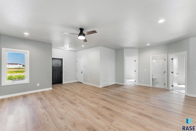 unfurnished living room with ceiling fan, a textured ceiling, and light wood-type flooring