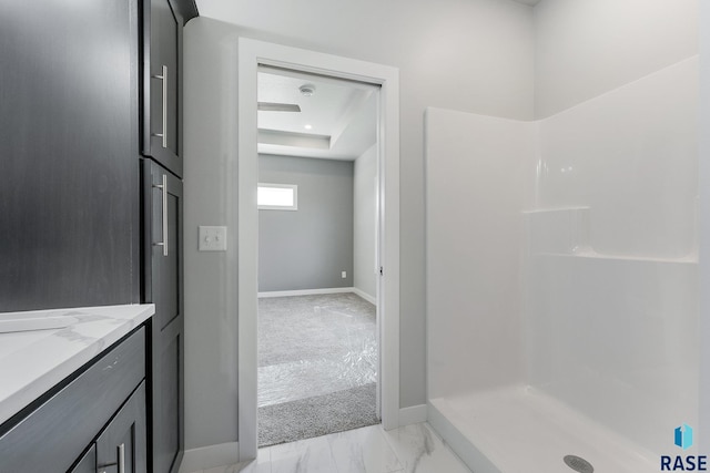 bathroom with walk in shower and vanity