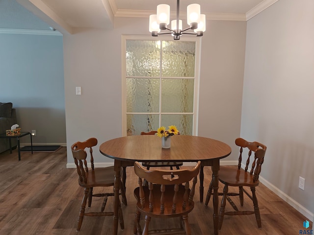 dining room featuring ornamental molding, an inviting chandelier, and dark hardwood / wood-style flooring