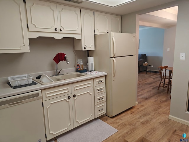 kitchen with light hardwood / wood-style flooring, white cabinets, white appliances, and sink