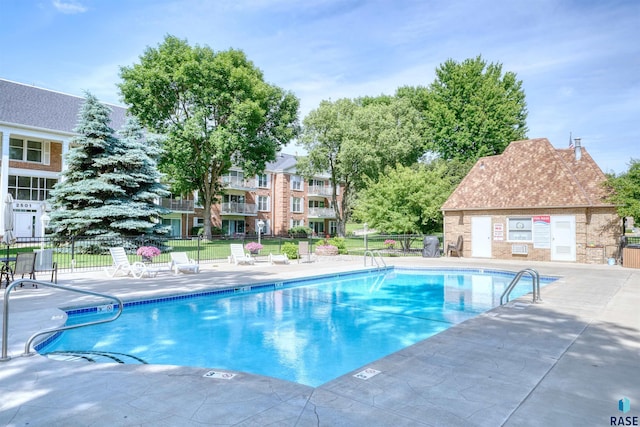 view of swimming pool featuring a lawn and a patio area