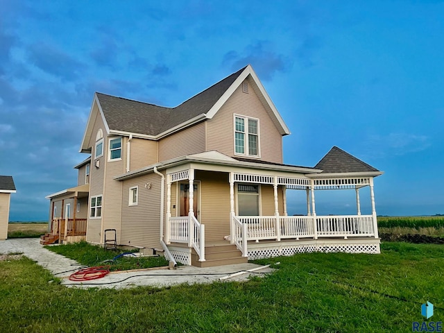 view of front facade with a front lawn and a porch