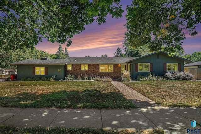 ranch-style house with a lawn