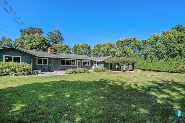 rear view of house with a lawn