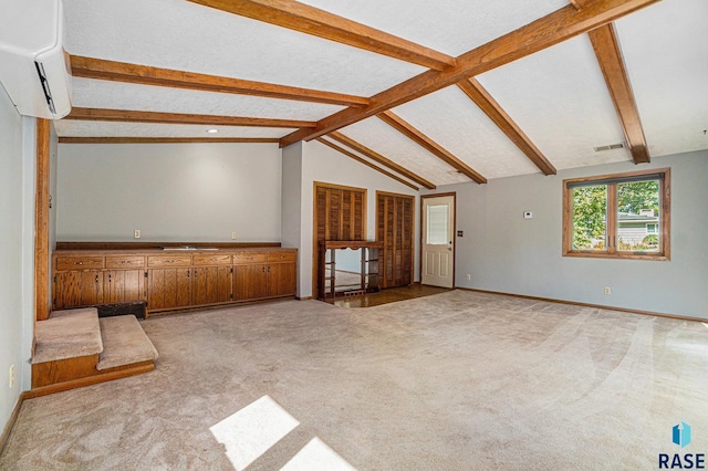 unfurnished living room with light carpet, lofted ceiling with beams, and an AC wall unit