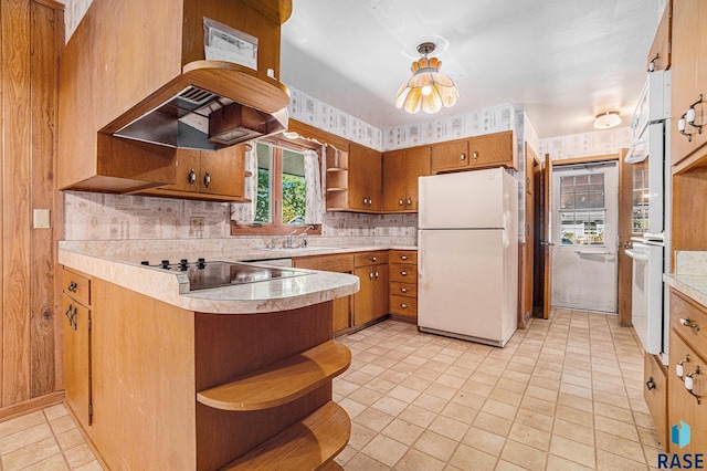 kitchen with sink, kitchen peninsula, white appliances, island exhaust hood, and decorative backsplash