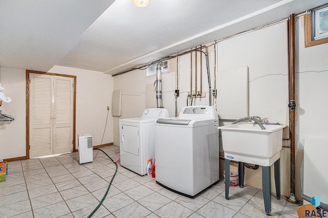 washroom with washing machine and dryer and sink