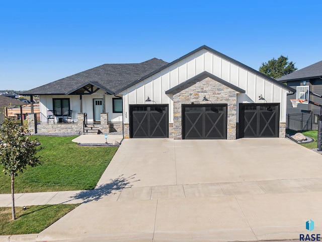 view of front of property featuring a garage and a front lawn