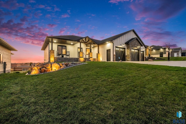 view of front of home with a yard and a garage