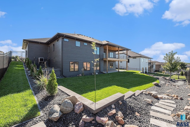 313 Red Spruce Ave, Sioux Falls, SD 57110 - rear view of house with a balcony, a fenced backyard, and a lawn
