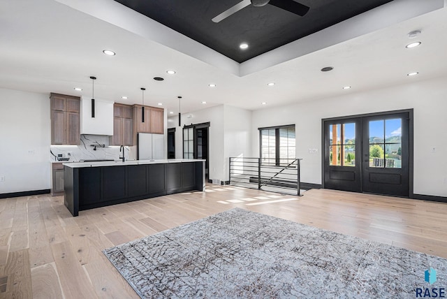 313 Red Spruce Ave, Sioux Falls, SD 57110 - kitchen with freestanding refrigerator, recessed lighting, light countertops, french doors, and light wood finished floors