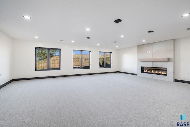 313 Red Spruce Ave, Sioux Falls, SD 57110 - unfurnished living room featuring light carpet, baseboards, and plenty of natural light