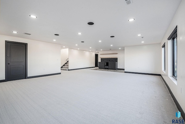 313 Red Spruce Ave, Sioux Falls, SD 57110 - unfurnished living room featuring light colored carpet, baseboards, and recessed lighting