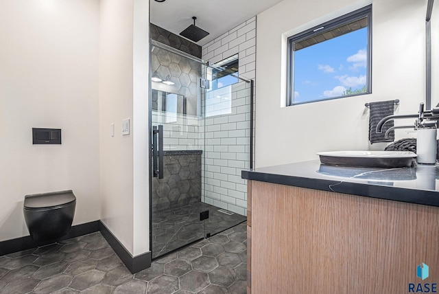 313 Red Spruce Ave, Sioux Falls, SD 57110 - full bath with a shower stall, vanity, toilet, tile patterned floors, and baseboards