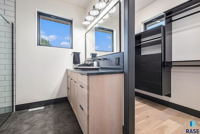 313 Red Spruce Ave, Sioux Falls, SD 57110 - bathroom with visible vents, baseboards, and vanity