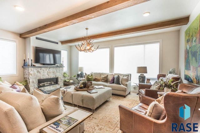 living room featuring a notable chandelier, beam ceiling, and a fireplace