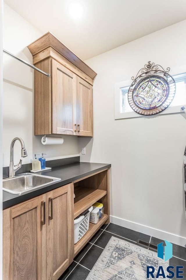 interior space featuring sink and dark tile patterned floors