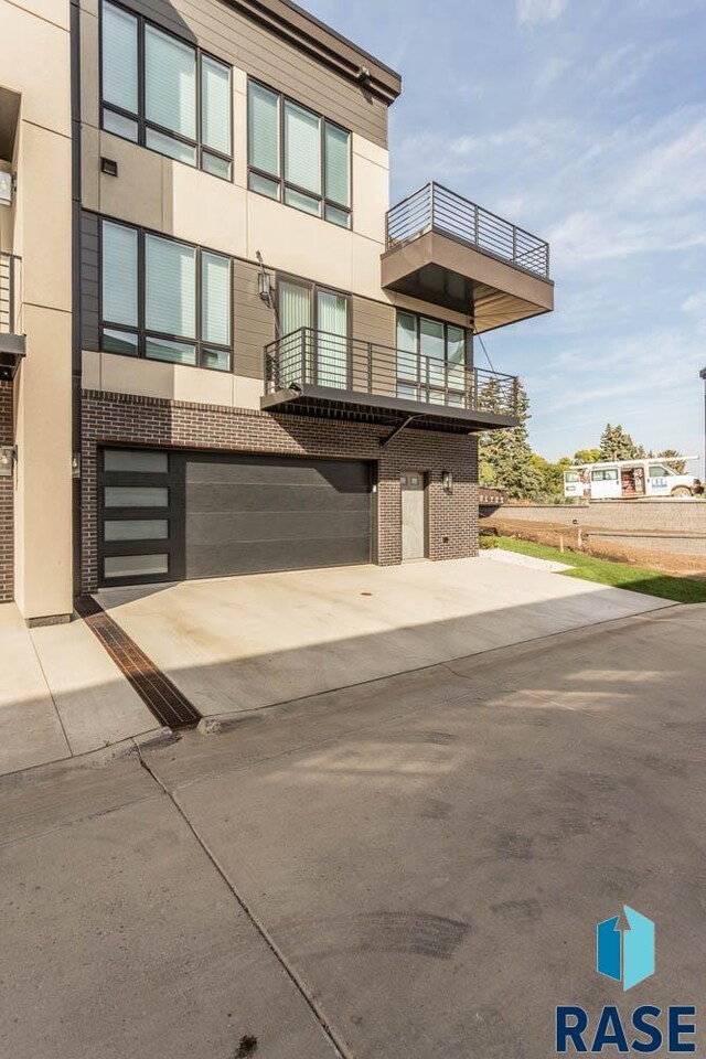 view of front of home with a balcony and a garage