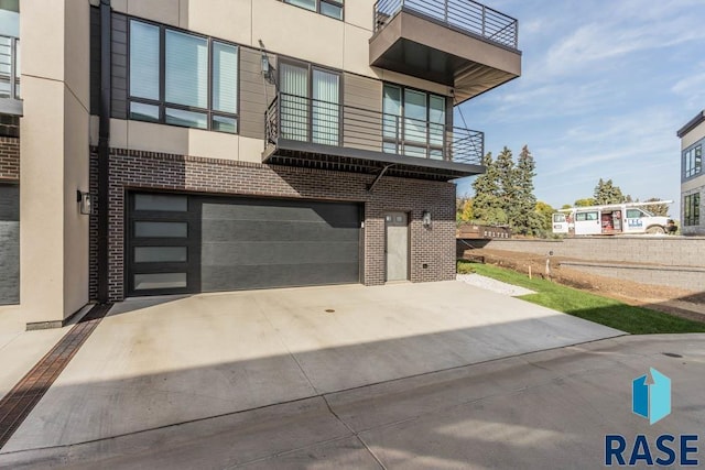 exterior space featuring a balcony and a garage