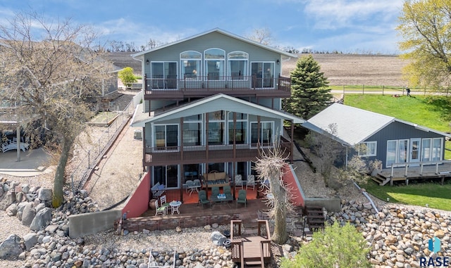 back of property featuring a patio and a deck