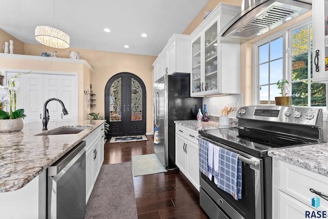 kitchen featuring appliances with stainless steel finishes, white cabinetry, sink, and dark hardwood / wood-style floors