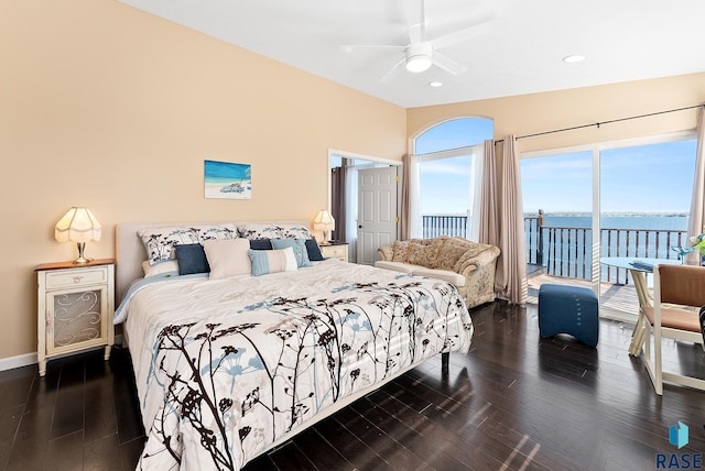 bedroom featuring a water view, ceiling fan, dark hardwood / wood-style floors, and access to exterior