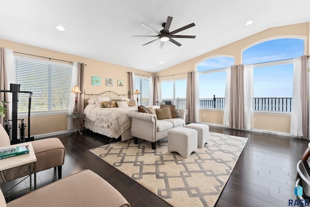 bedroom featuring ceiling fan, lofted ceiling, dark hardwood / wood-style flooring, and multiple windows