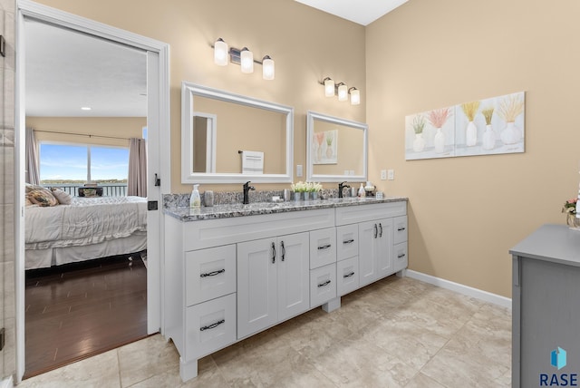 bathroom with lofted ceiling, hardwood / wood-style flooring, and vanity