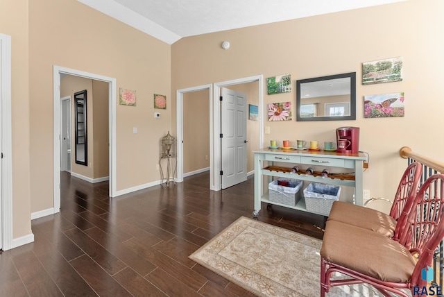 sitting room with lofted ceiling and dark hardwood / wood-style floors