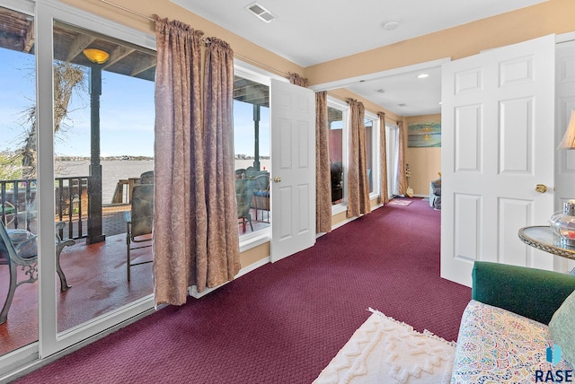 corridor featuring a water view and carpet