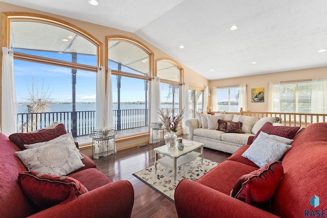 living room with a water view, vaulted ceiling, and dark wood-type flooring