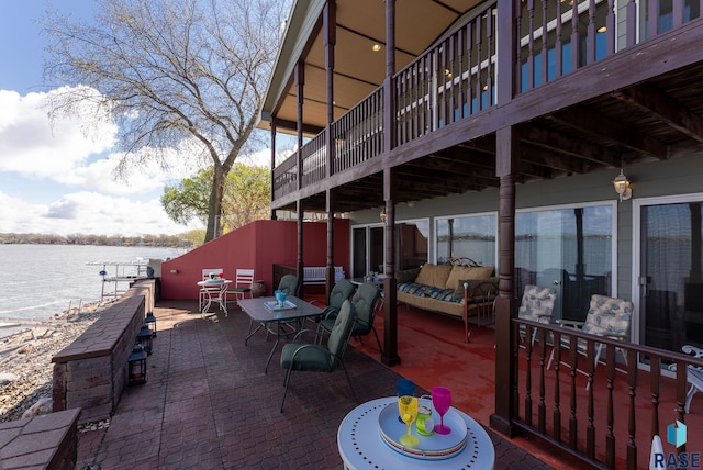 view of patio featuring an outdoor hangout area and a deck with water view