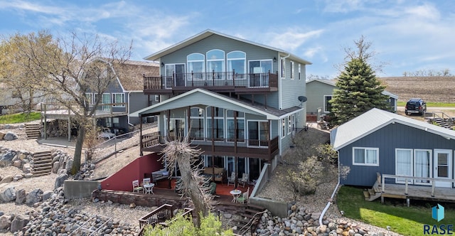 back of house featuring a balcony and a patio area