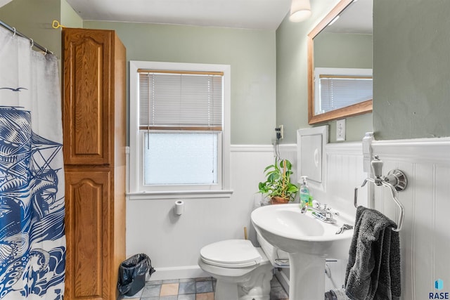 bathroom with toilet and tile patterned floors