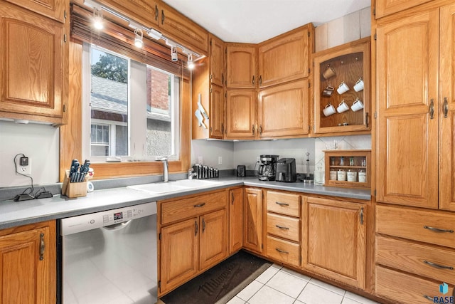 kitchen with light tile patterned floors, dishwasher, and sink