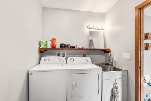 laundry room with cabinets, sink, and washing machine and clothes dryer