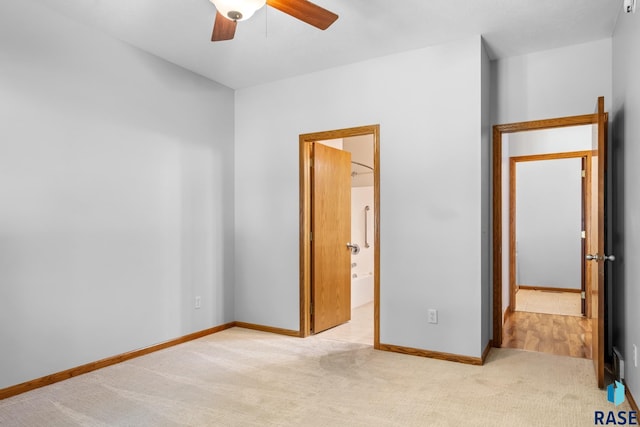 unfurnished bedroom with carpet flooring, a ceiling fan, and baseboards