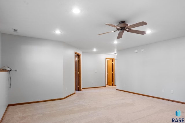 unfurnished room with recessed lighting, light colored carpet, visible vents, ceiling fan, and baseboards