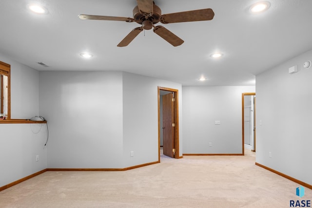 empty room featuring light carpet, baseboards, visible vents, and recessed lighting