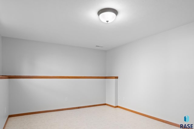 spare room featuring baseboards